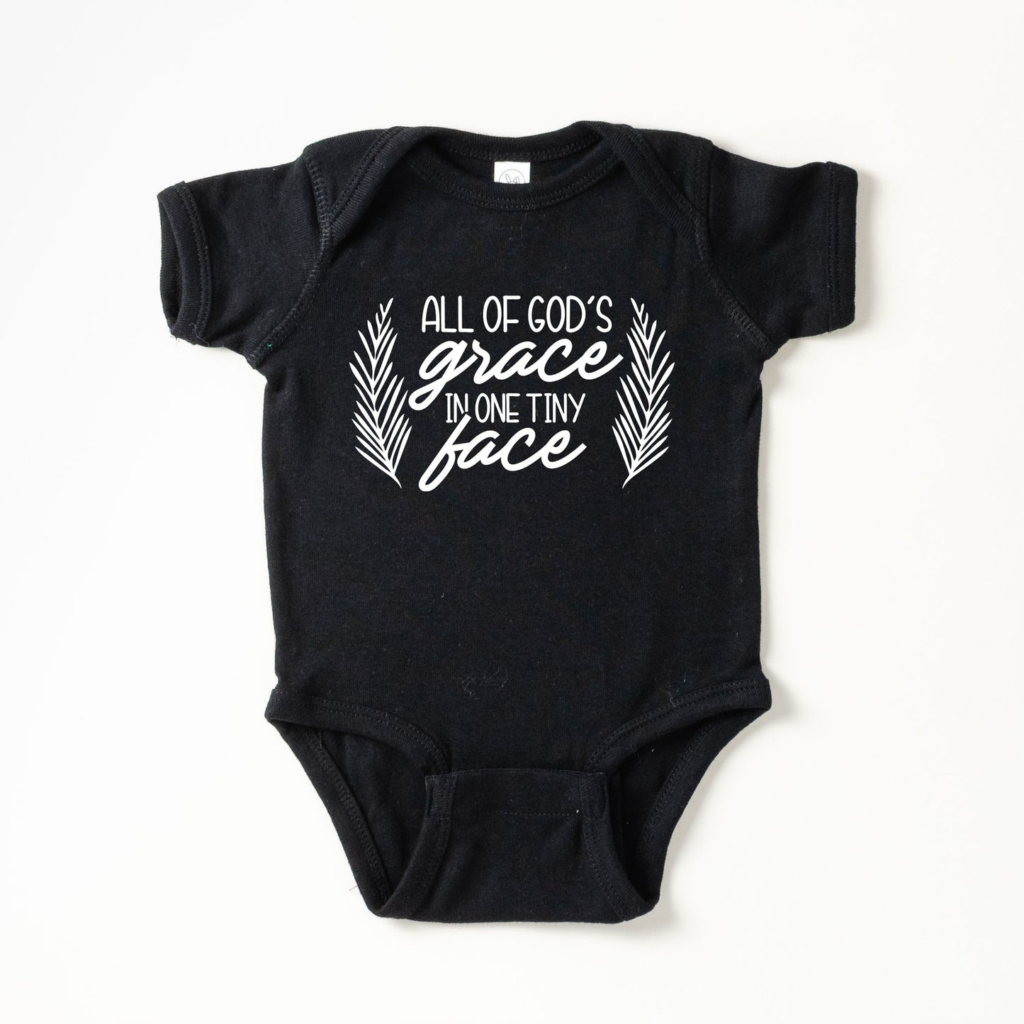 All Of God's Grace In One Tiny Face | Baby Graphic Short Sleeve Onesie by The Juniper Shop