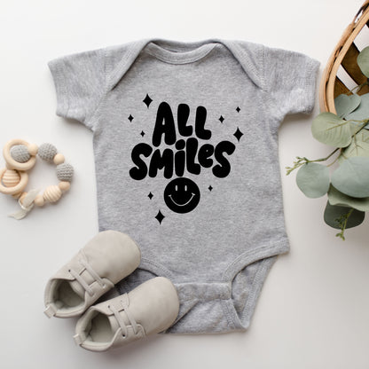 All Smiles Smiley Face | Baby Graphic Short Sleeve Onesie by The Juniper Shop