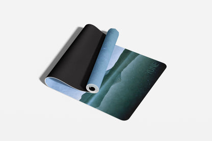 Three yoga mats in black, blue, and green on a light gray background