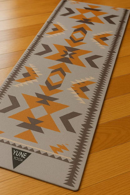 Yune Yoga mat with geometric pattern on a wooden floor