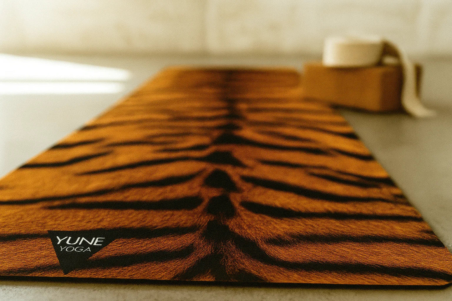 Yume Yoga mat with tiger stripe pattern on a neutral background