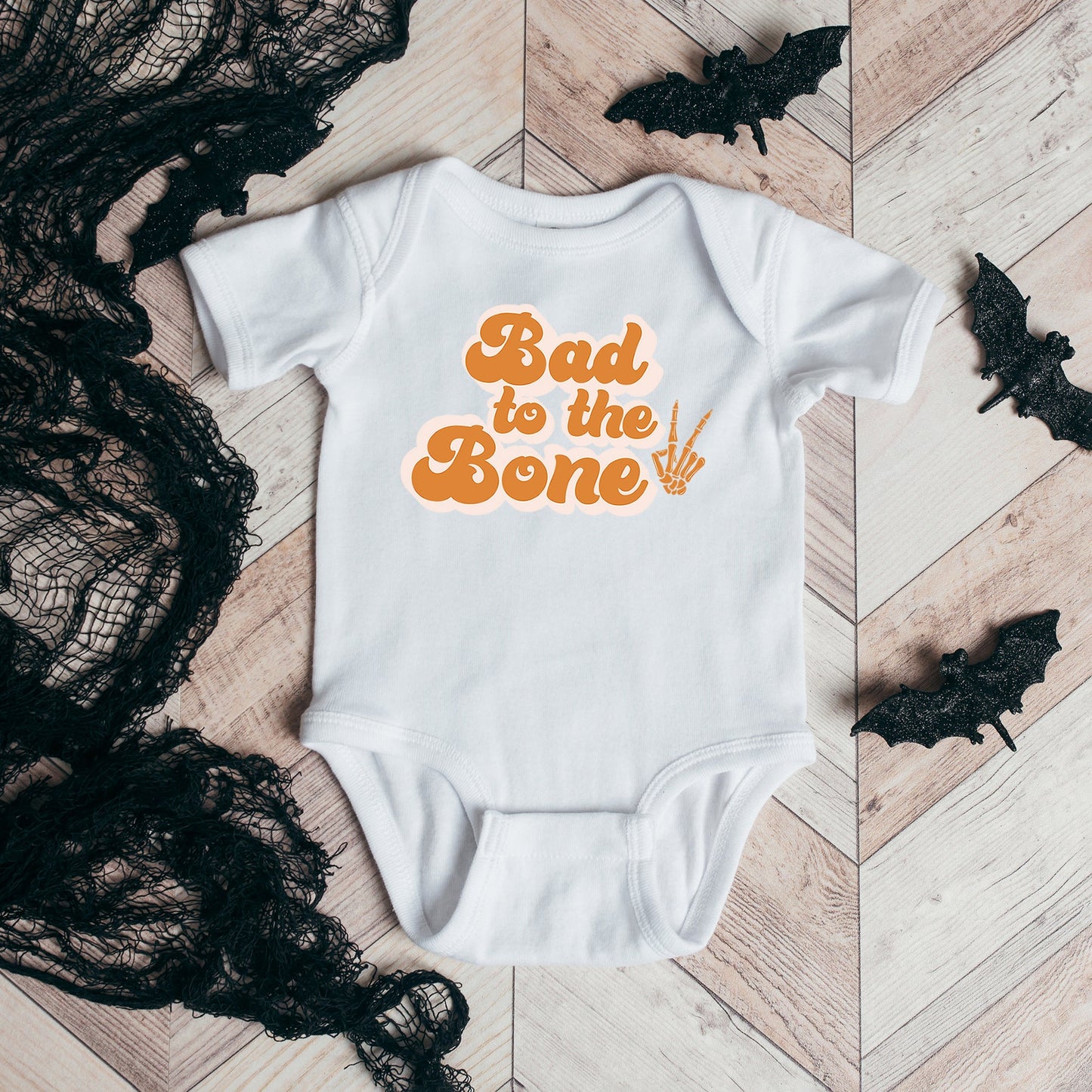 Bad To The Bone Hand | Baby Graphic Short Sleeve Onesie by The Juniper Shop