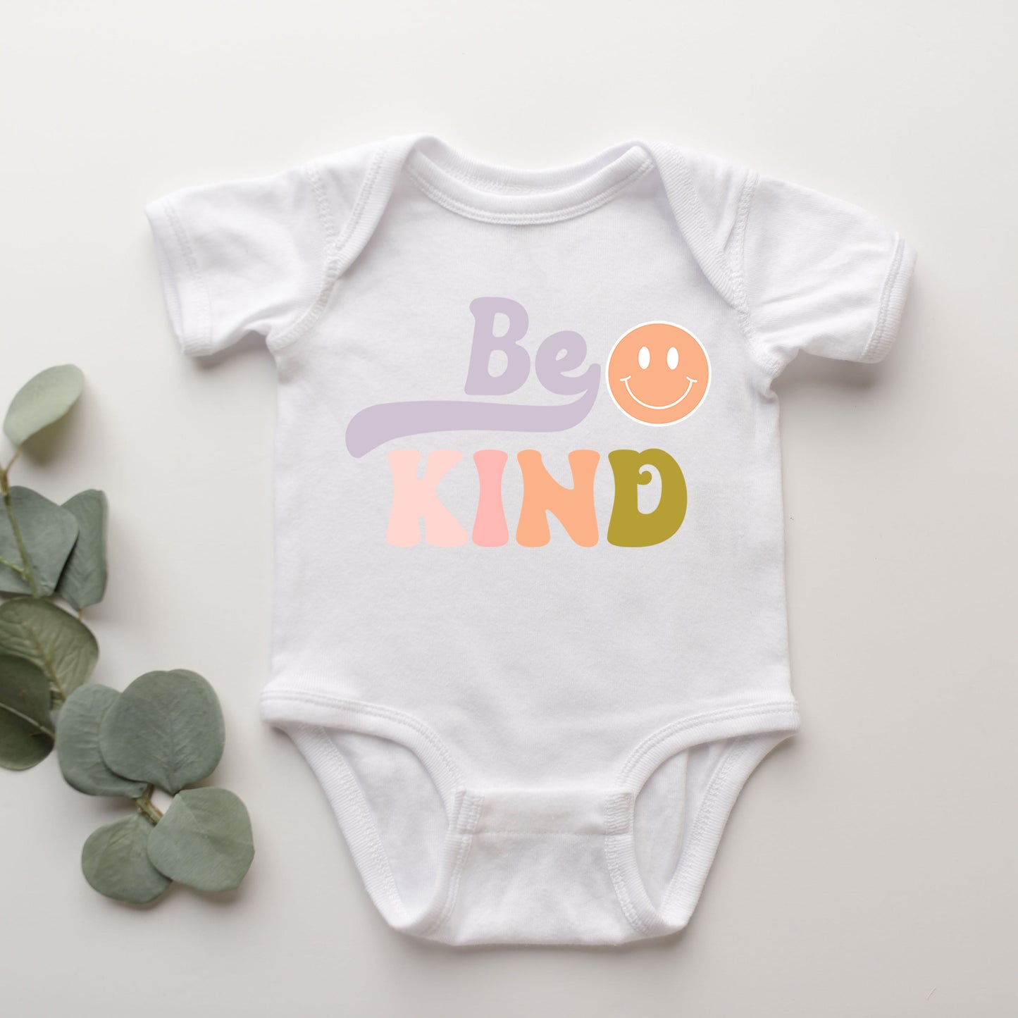 Be Kind Smiley Face | Baby Graphic Short Sleeve Onesie by The Juniper Shop