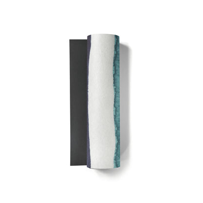 Decorative wall sconce with black base and white body with green accents on a white background