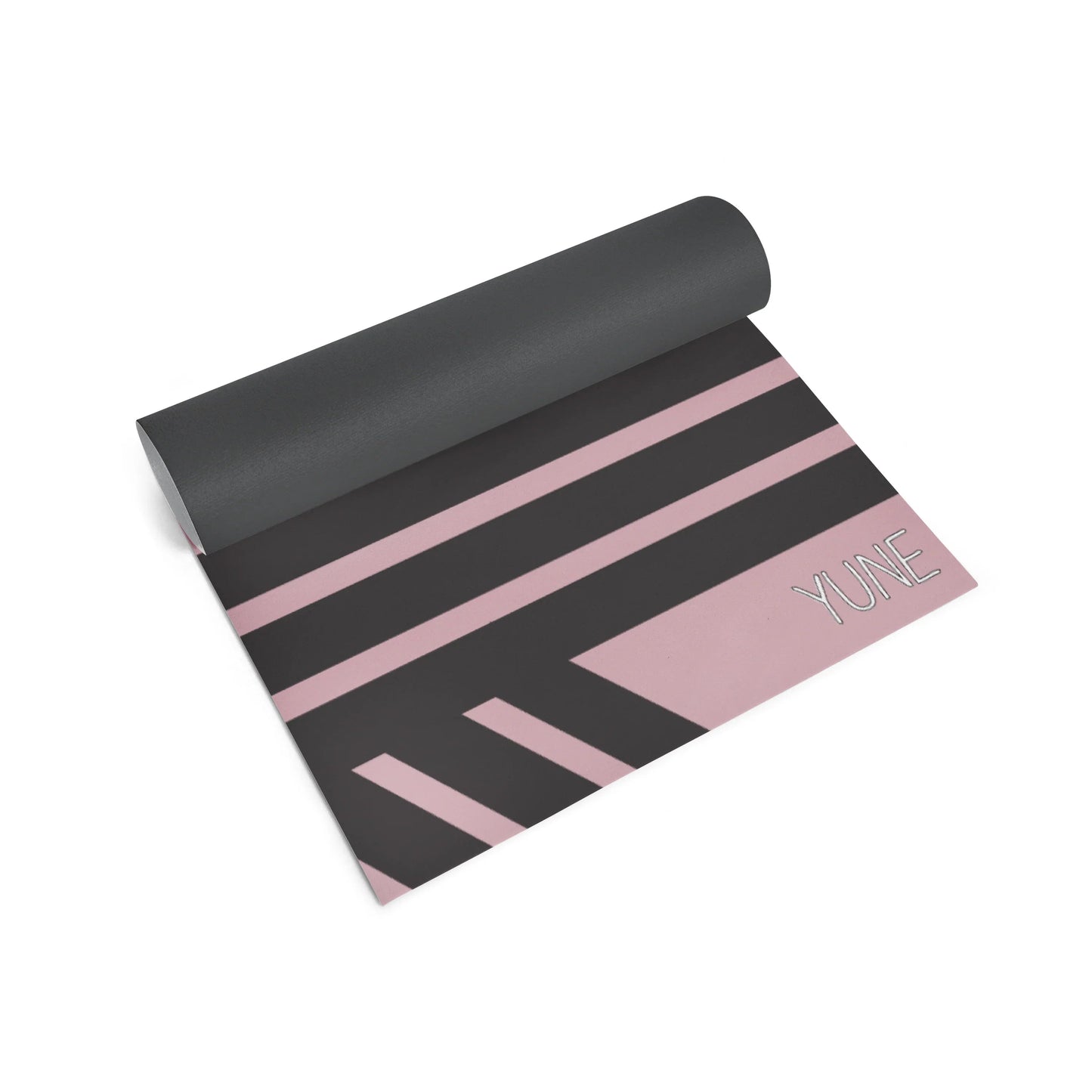 Yoga mat with pink stripes and 'YUNE' branding on a white background