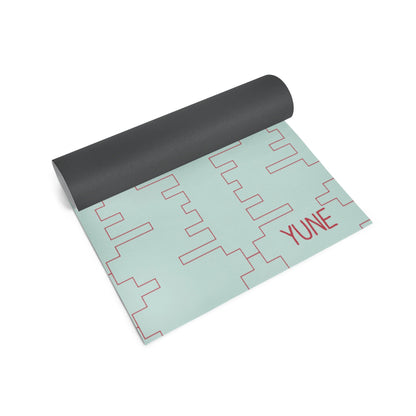 Yoga mat with geometric pattern and 'YUNE' branding on a white background