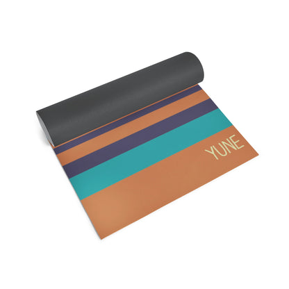 Yoga mat with striped design and 'YUNE' branding on a white background