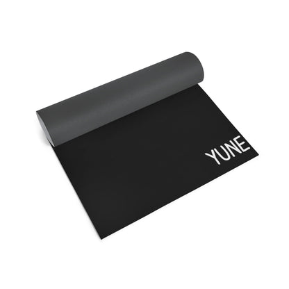 Black yoga mat with 'YUNE' branding on a white background