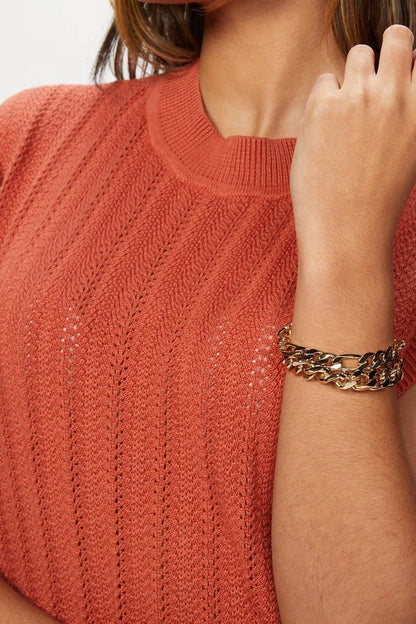 Coral knit top with Axel Bracelet for a stylish summer look
