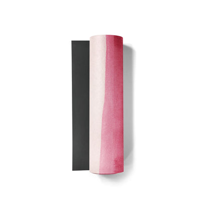 Two cylindrical objects, one black and one pink, on a white background