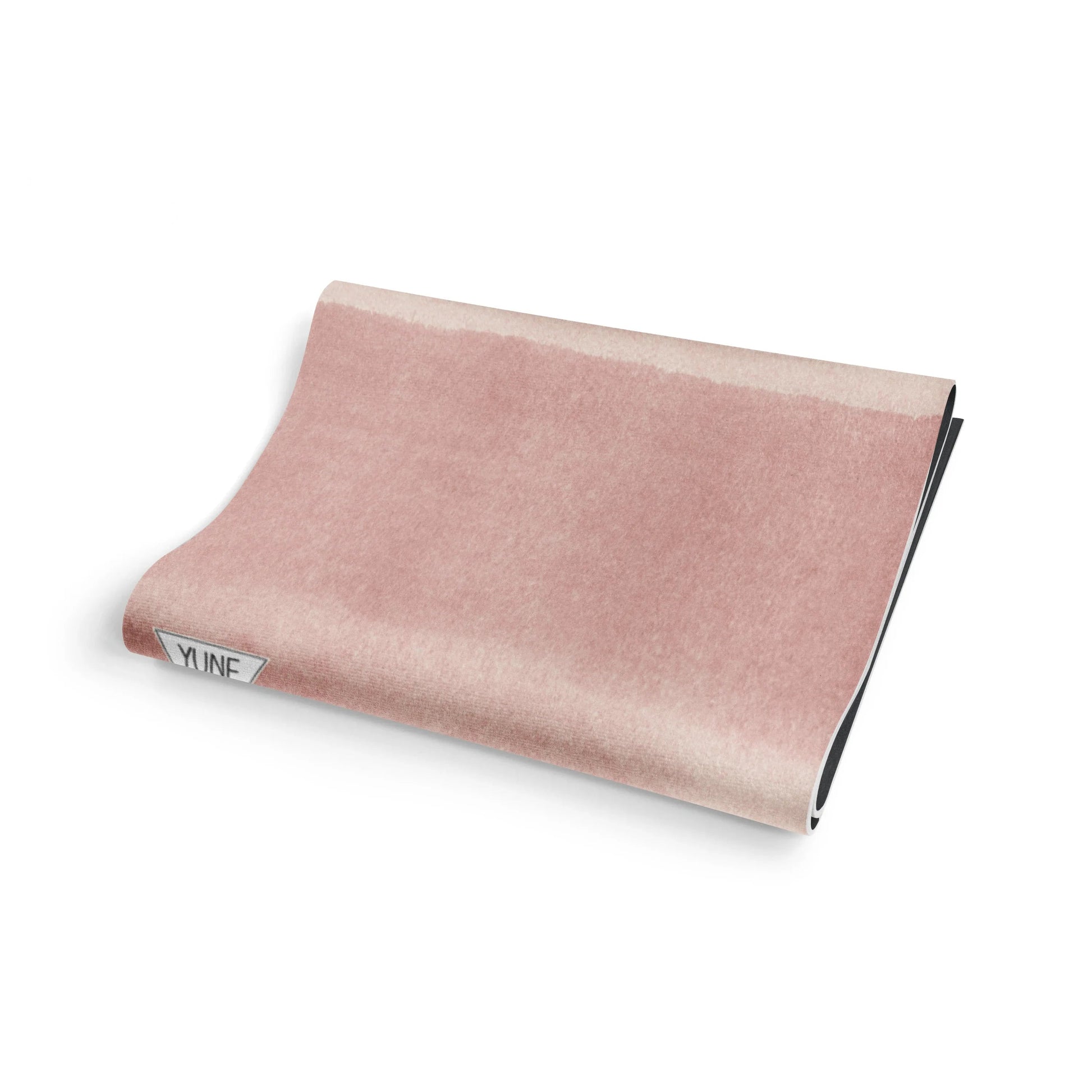 Pink travel pillow with 'Ynfm' branding on a white background